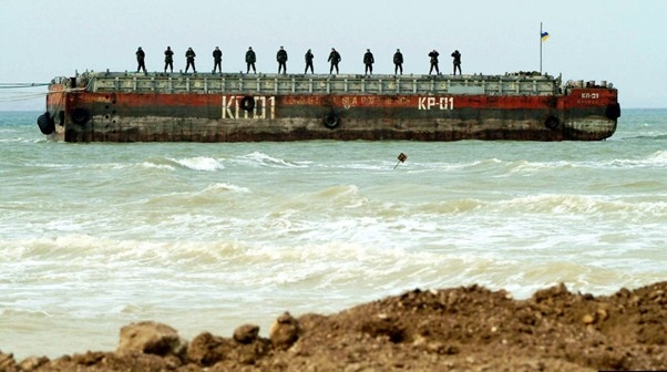 Українські прикордонники на понтоні спостерігають за будівництвом дамби